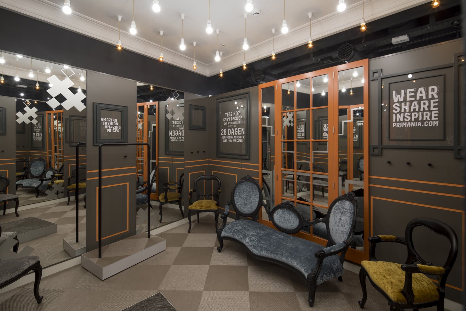 Men's dressing room with wall mirrors and handing ceiling bulbs