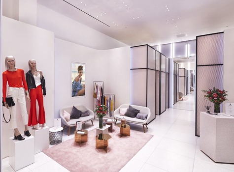 Women's dressing room with natural white light, mirrors and seating area