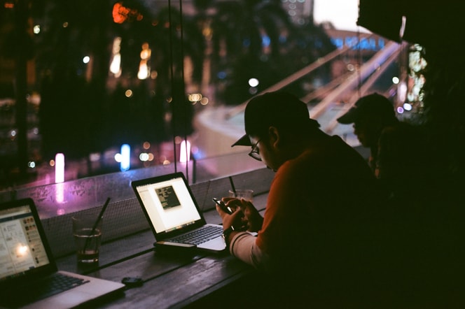 People working on laptops at night